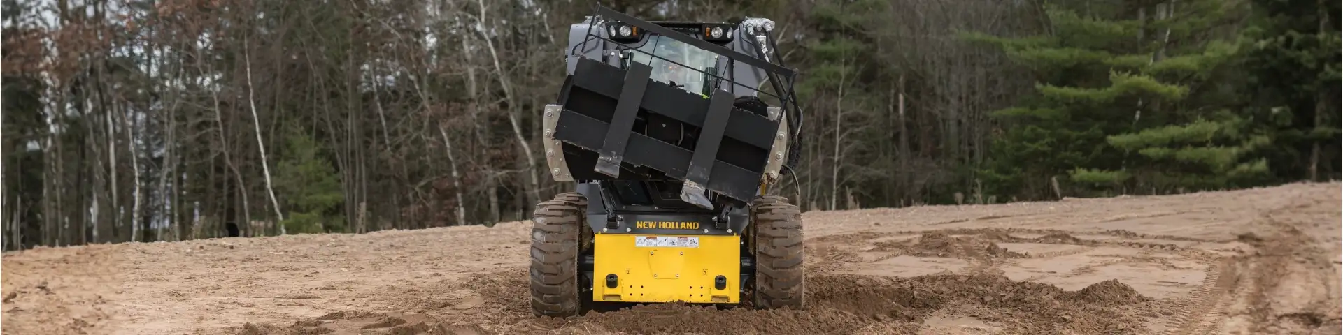 Skid steer loader with tilt attachment.