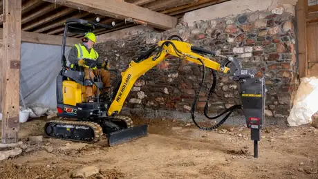New Holland Construction E15X with hydraulic hammer attached.