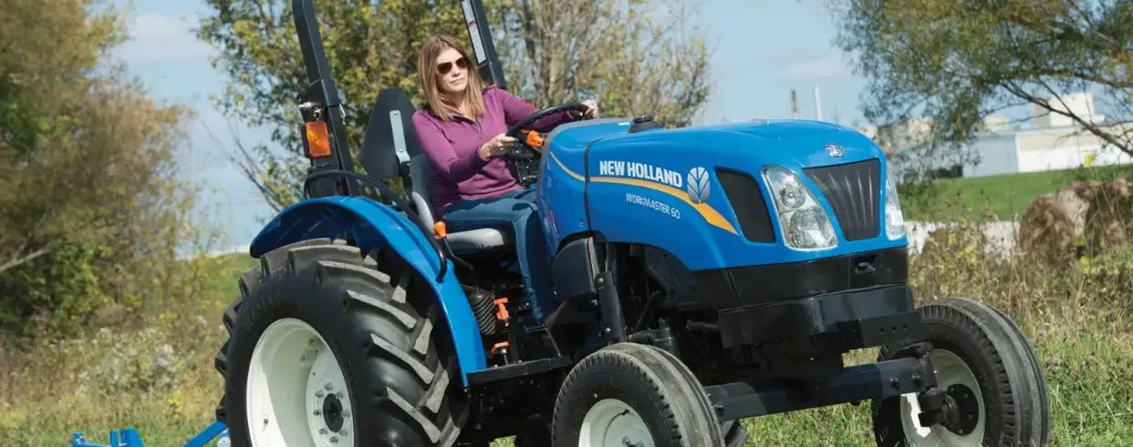 Woman operates WORKMASTER tractor 