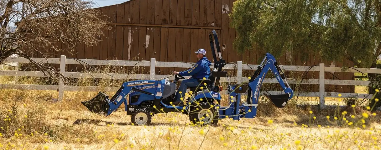WORKMASTER 25S tractor with a bucket and backhoe