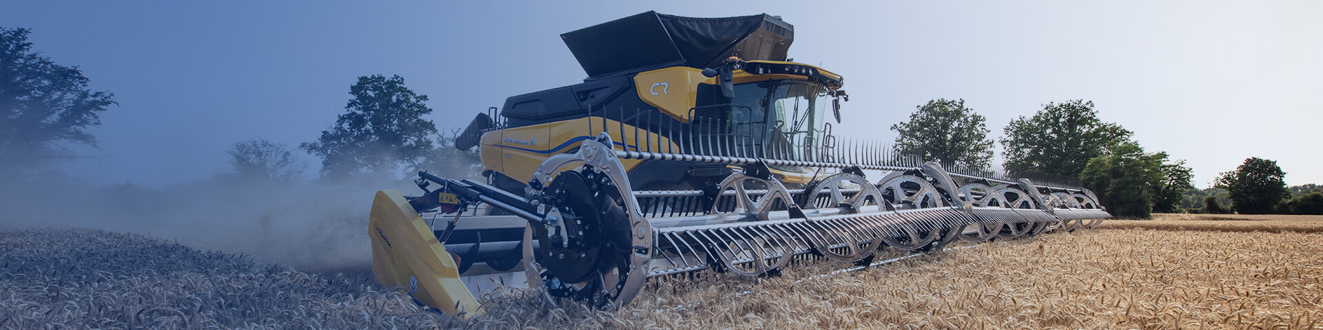 New Holland CR combine working in field with blue overlay