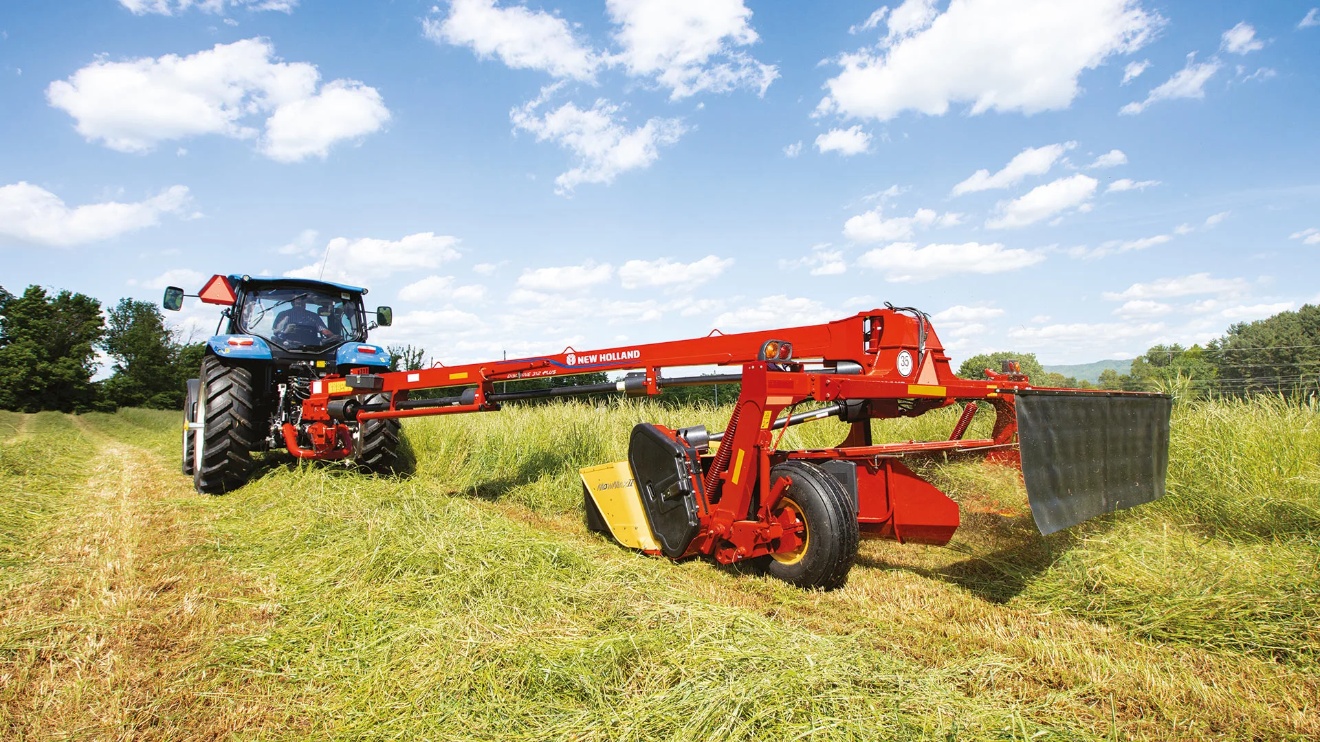 Discbine® PLUS Center-Pivot Disc Mower-Conditioner pulled by a tractor in the field