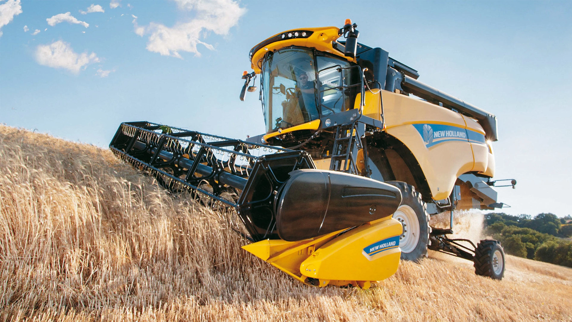 New Holland combine in action, efficiently harvesting with High Capacity Grain Headers
