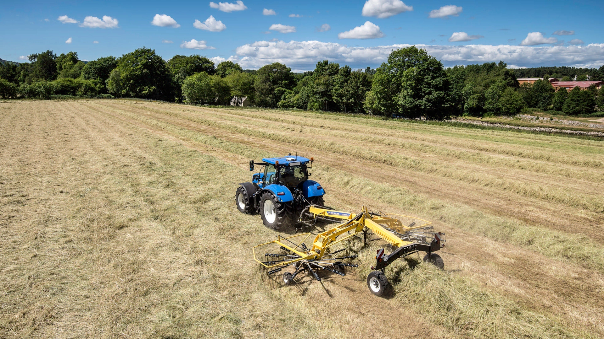 Tractor with Prorotor C Twin Rotor Rake working on the field