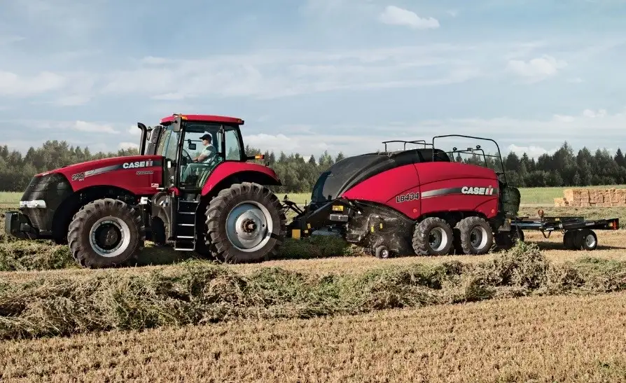 Case Magnum 290 tractor and LB434 baler in a field.