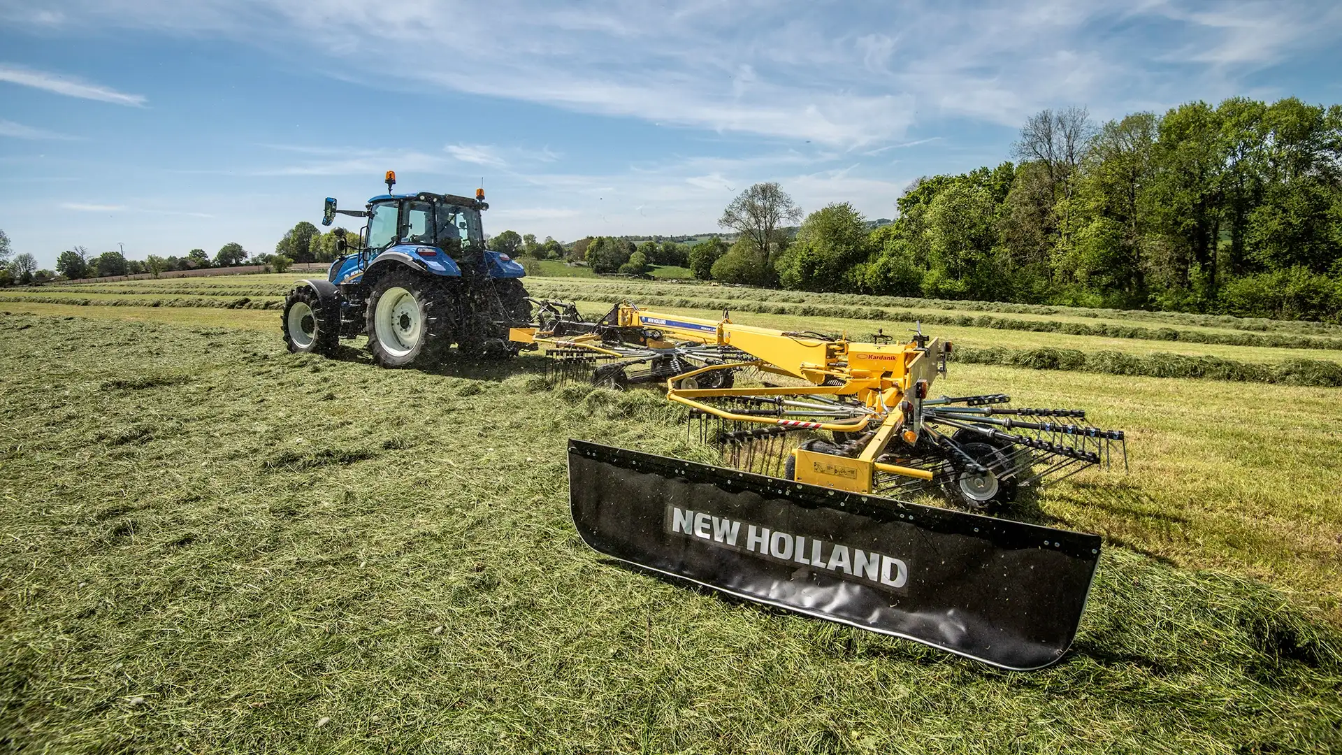Tractor with Prorotor L Twin Rotor Rake working on the field