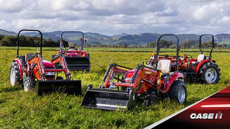 Case IH Farmall B tractor line up sitting in field with New Zealand backdrop