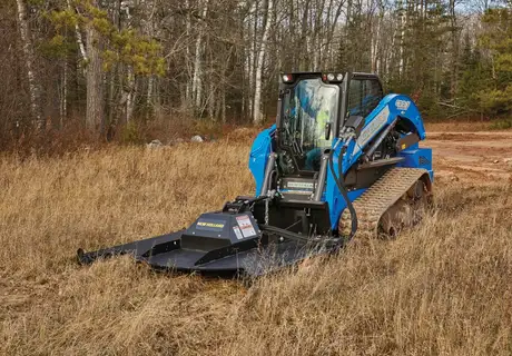 New Holland compact track loader with brush mower attachment