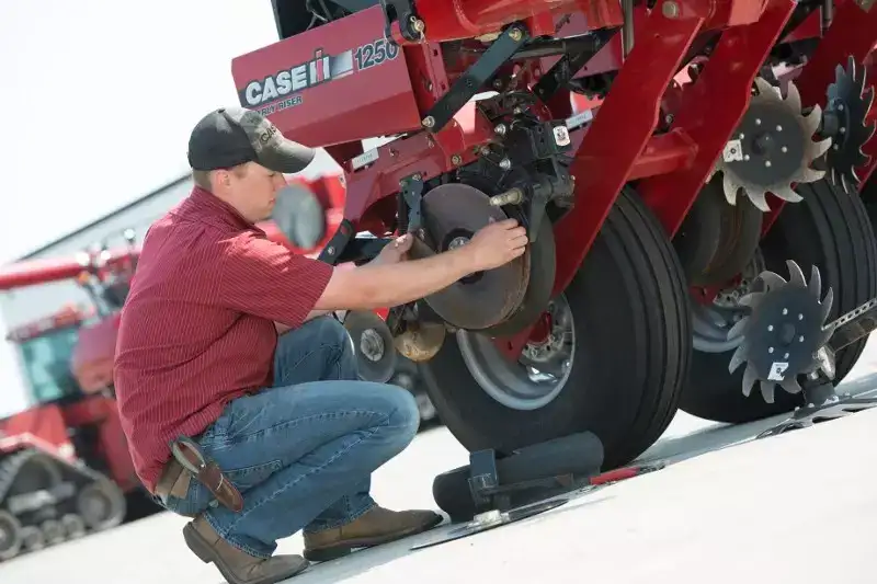 Case IH Technician adjusting Early Riser Planter wheel