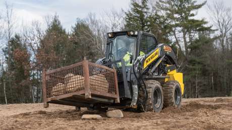 New Holland Construction L328 lifting rocks.