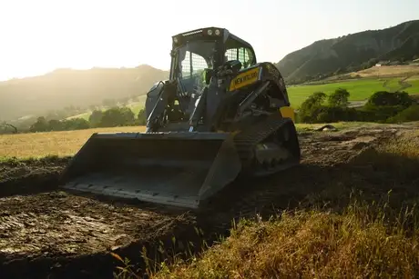 studio photo with the New Holland C345 skid steer loader, highlighting the