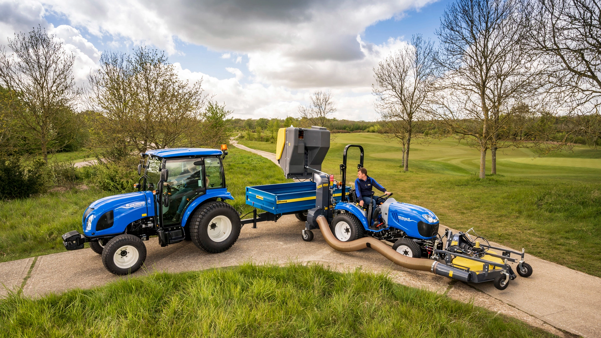 New Holland Boomer farm tractors performing duties on fields