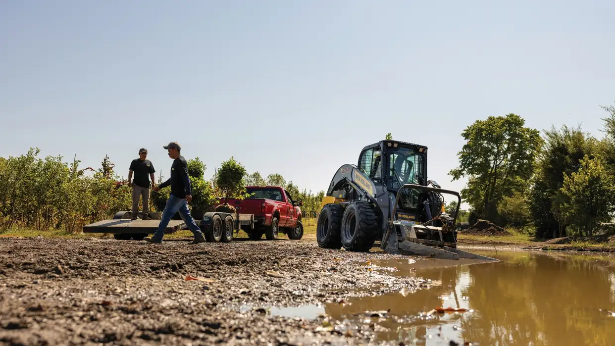 Two men working in muddy field.