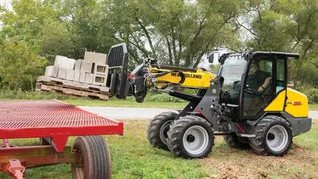 New Holland Construction ML35T lifting cinder blocks.
