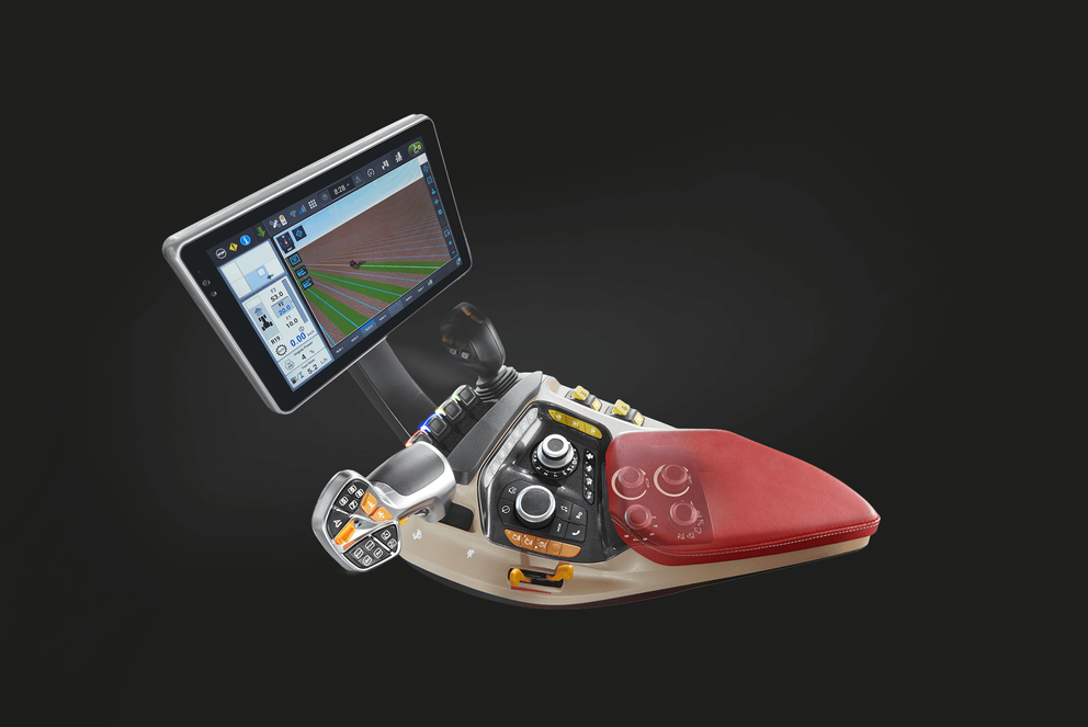Case IH tractor cab armrest console featuring a multi-function joystick, control dials and buttons, and a touchscreen display showing a field guidance map, isolated on a black studio background.