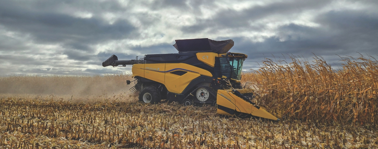 New Holland combine with corn header in the field