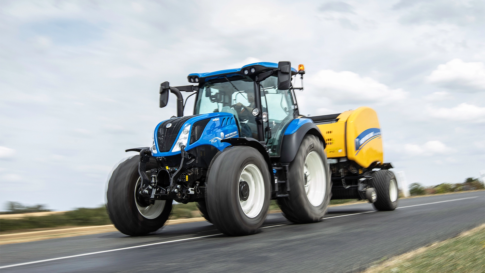 New Holland T5 Dynamic Command & Auto Command tractor transporting a baler
