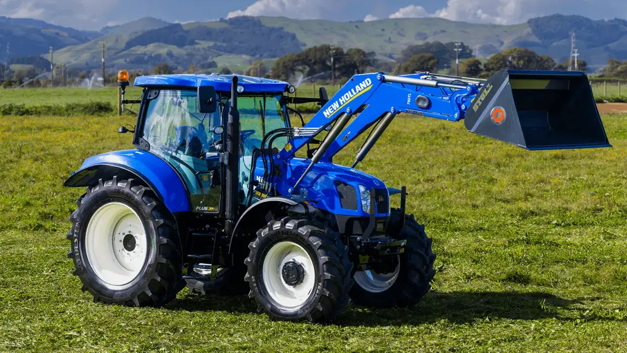 New Holland T6000 Tier 3 tractor sitting in New Zealand field, with loader configuration