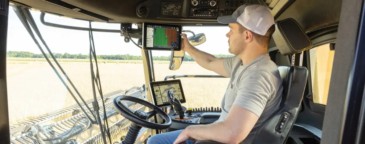 Operator in the cabin of a Next Generation CR Series combine