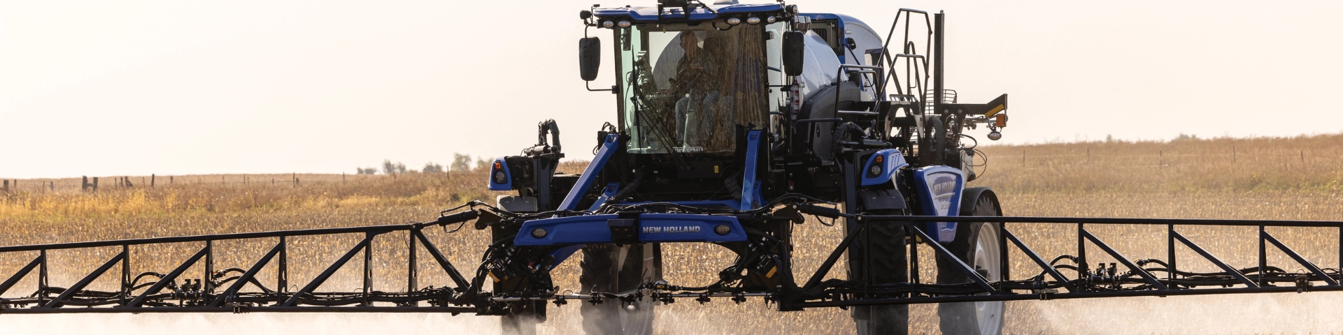 Blue sprayer spraying crops.