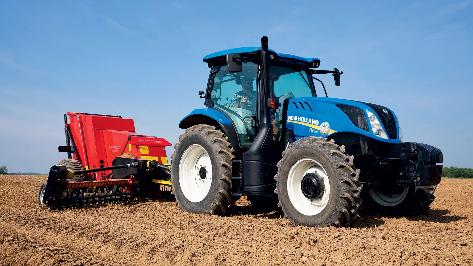 T6 Series tractor pulls an implement