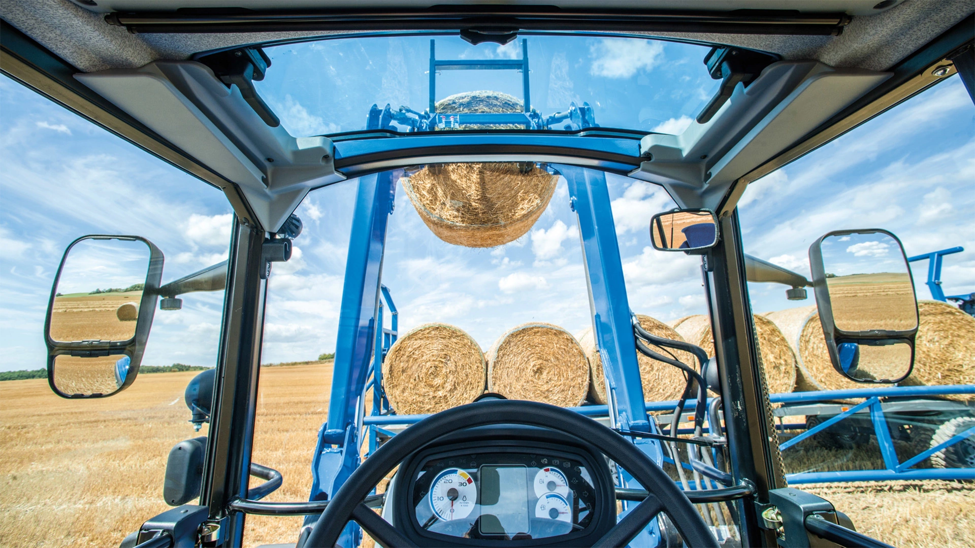 Driver's perspective from within the New Holland T5 Electro Command farming tractor cabin