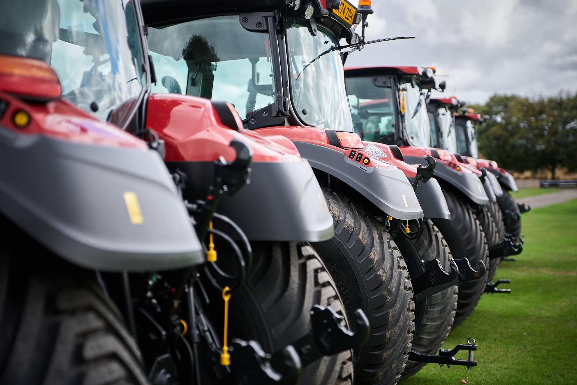 Row of Case IH tractors displayed on the grounds of Cowdray Park Polo Club.