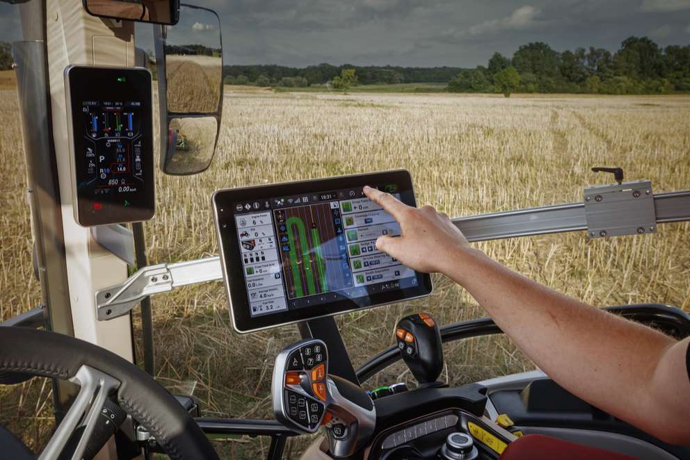 Interior of a Case IH tractor cab with a touchscreen display for controlling agricultural operations and precision guidance.