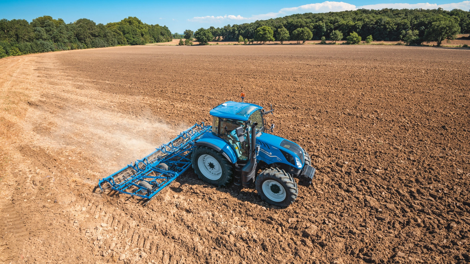Agricultural field being tended by New Holland T5 Electro Command farming tractor