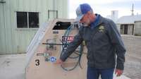 Man pointing to a compressed natural gas sticker on a methane pump.