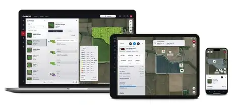Case IH FieldOps software displayed on a laptop, tablet, and smartphone. Screens show maps of fields with data overlays, conveying precision agriculture technology.
