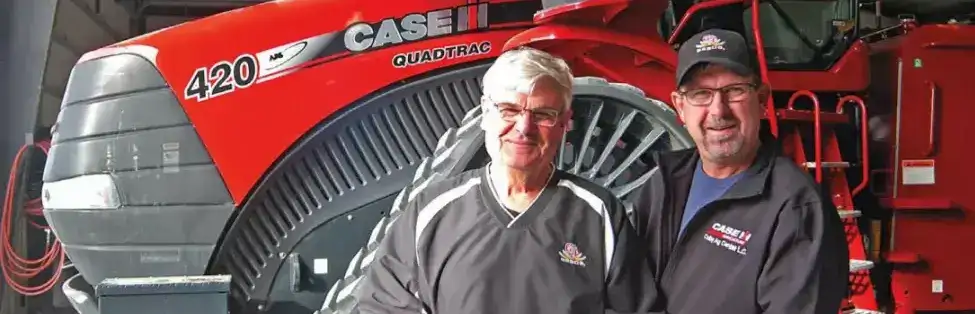 Jim Tubbs and his son, George, next to a Steiger 420 tractor.