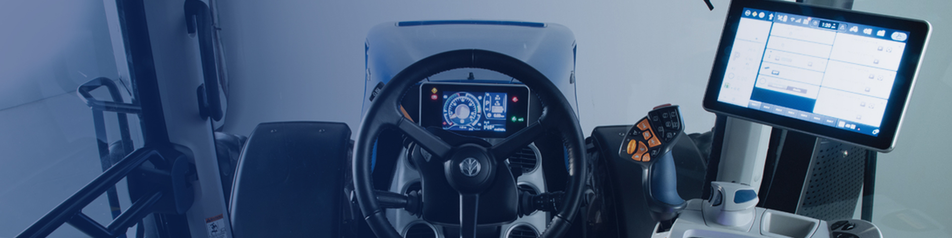 New Holland interior tractor shot with steering wheel and display
