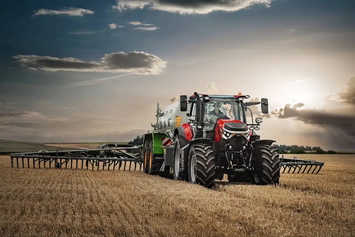 Red Case IH Puma next generation tractor sitting in field with implement attached