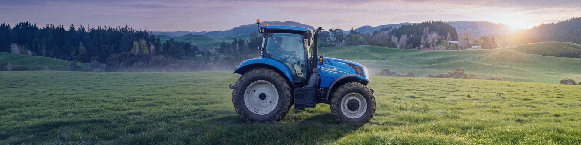 New Holland T7 tractor working in New Zealand field with sky background