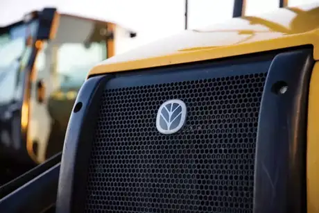 New Holland logo on the front of equipment