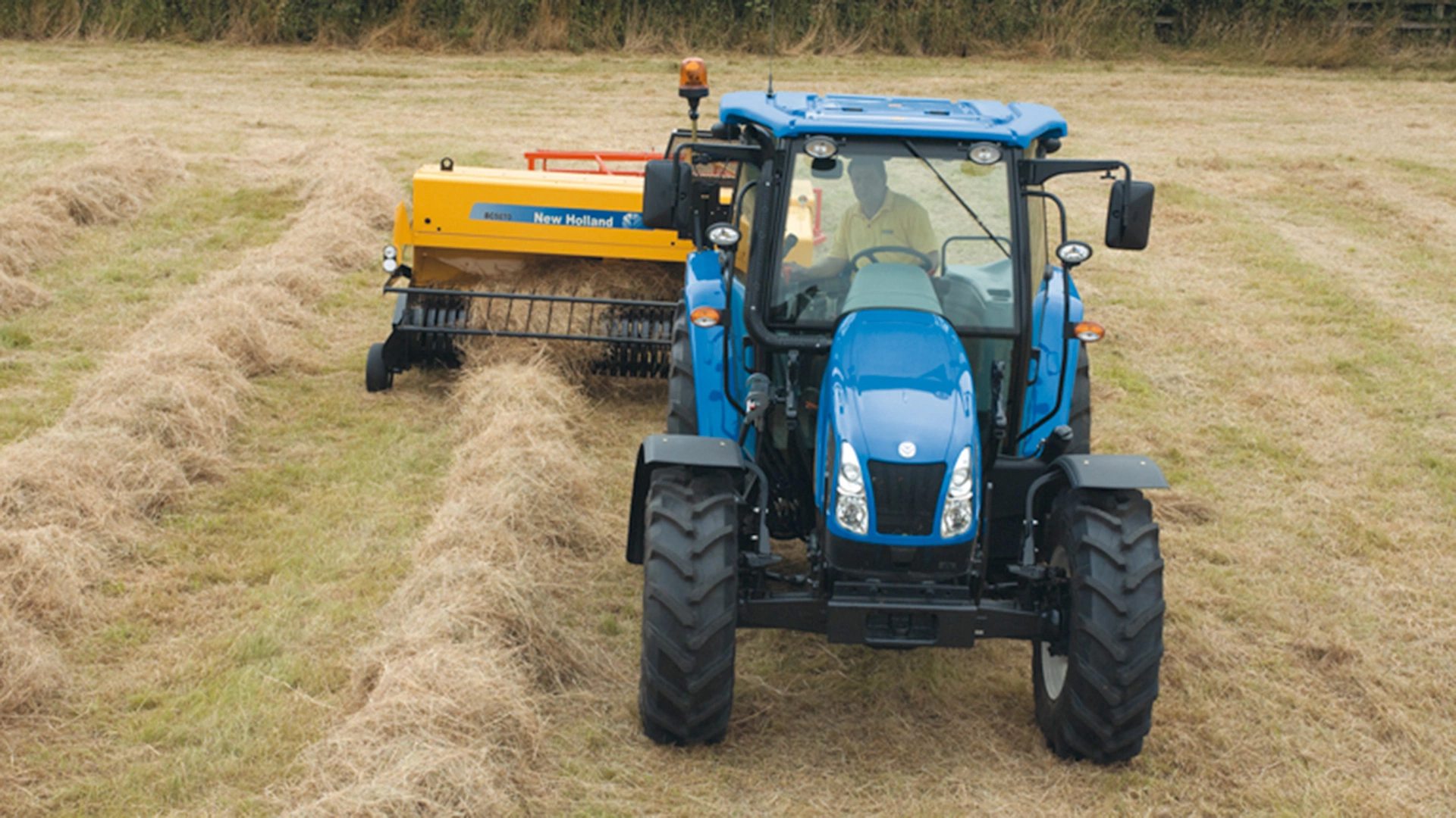 New Holland Tractor with BC5000 baler on the field