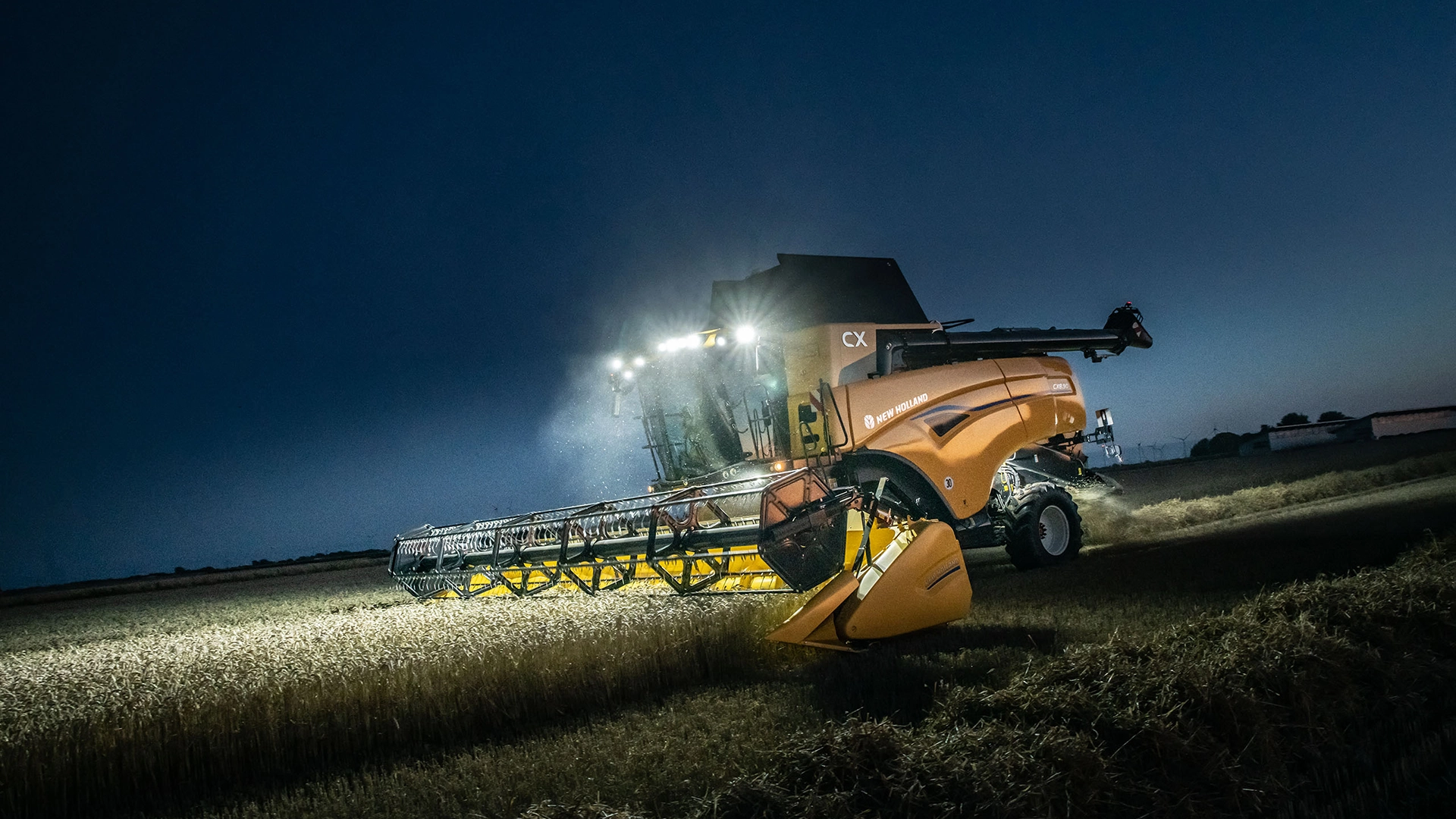New Holland's CX7 & CX8 combines working in tandem with tractors during the night, maximising agricultural productivity