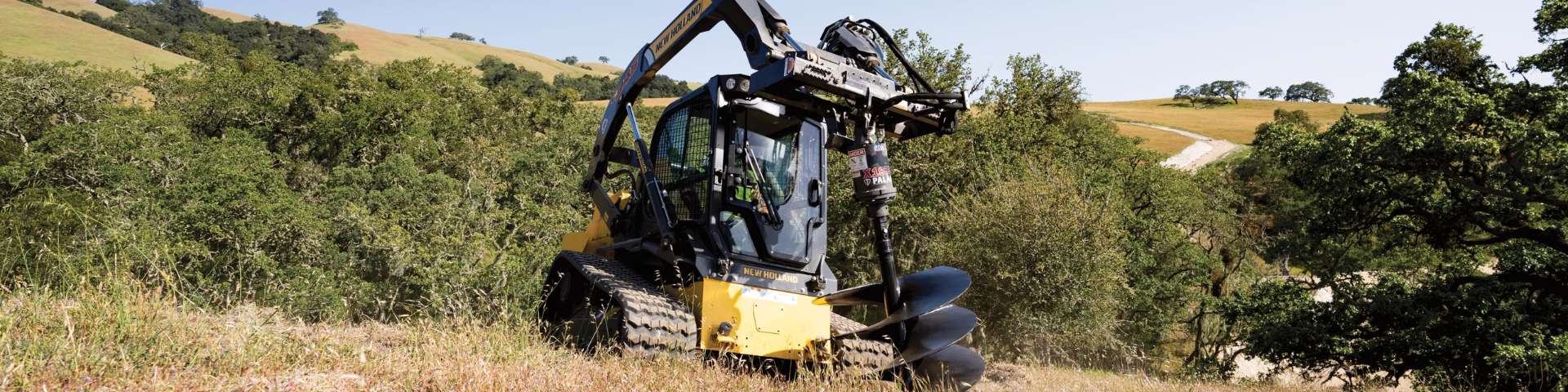 Compact track loader with auger.