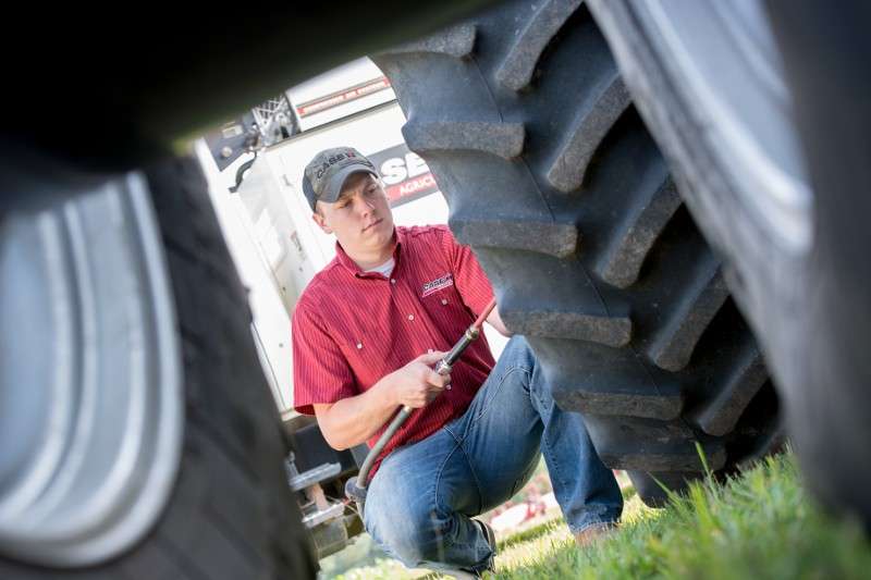 Case IH technician adding air to tires