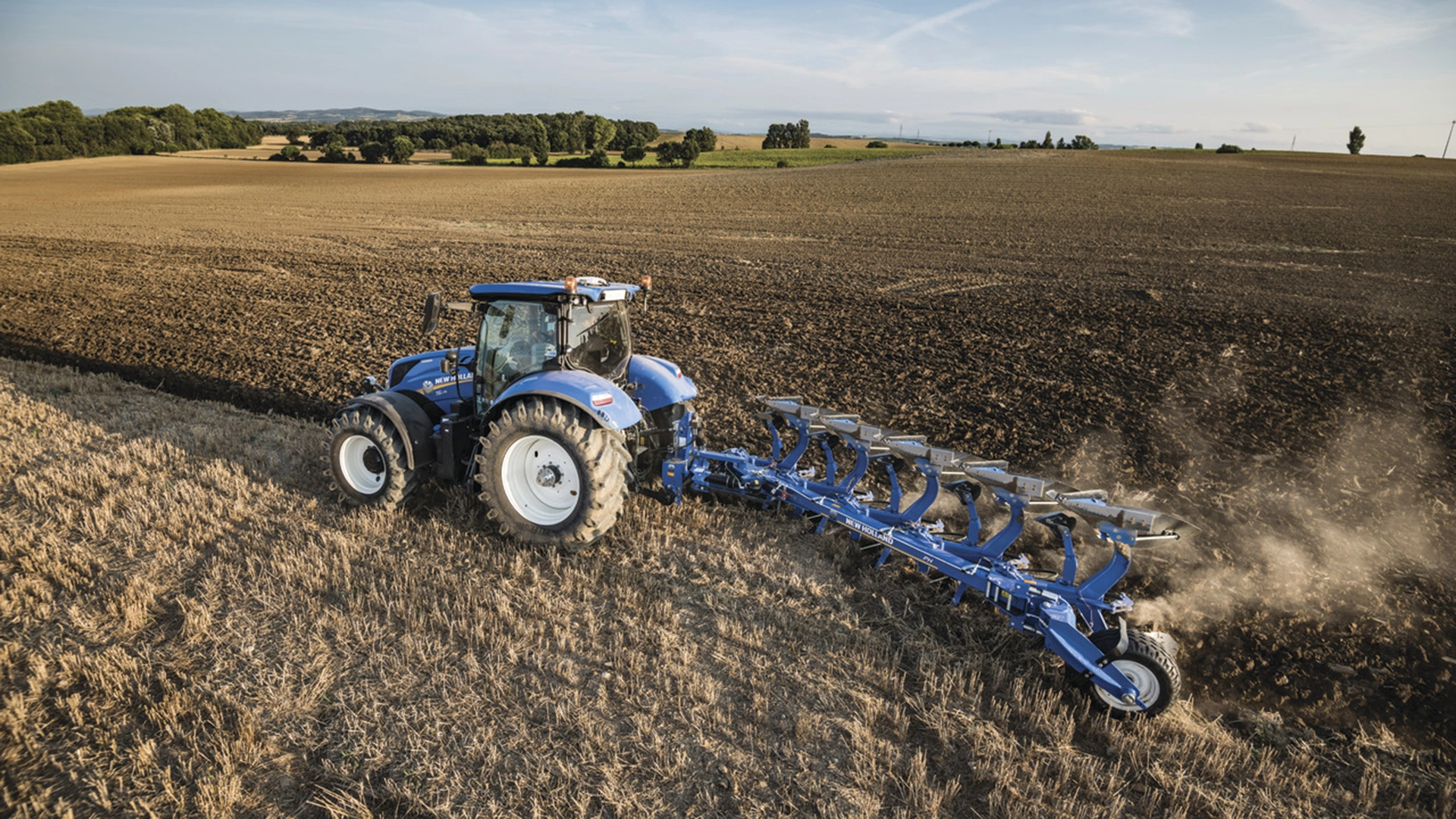 New Holland's Tractor with a 5 furrow reversible plough