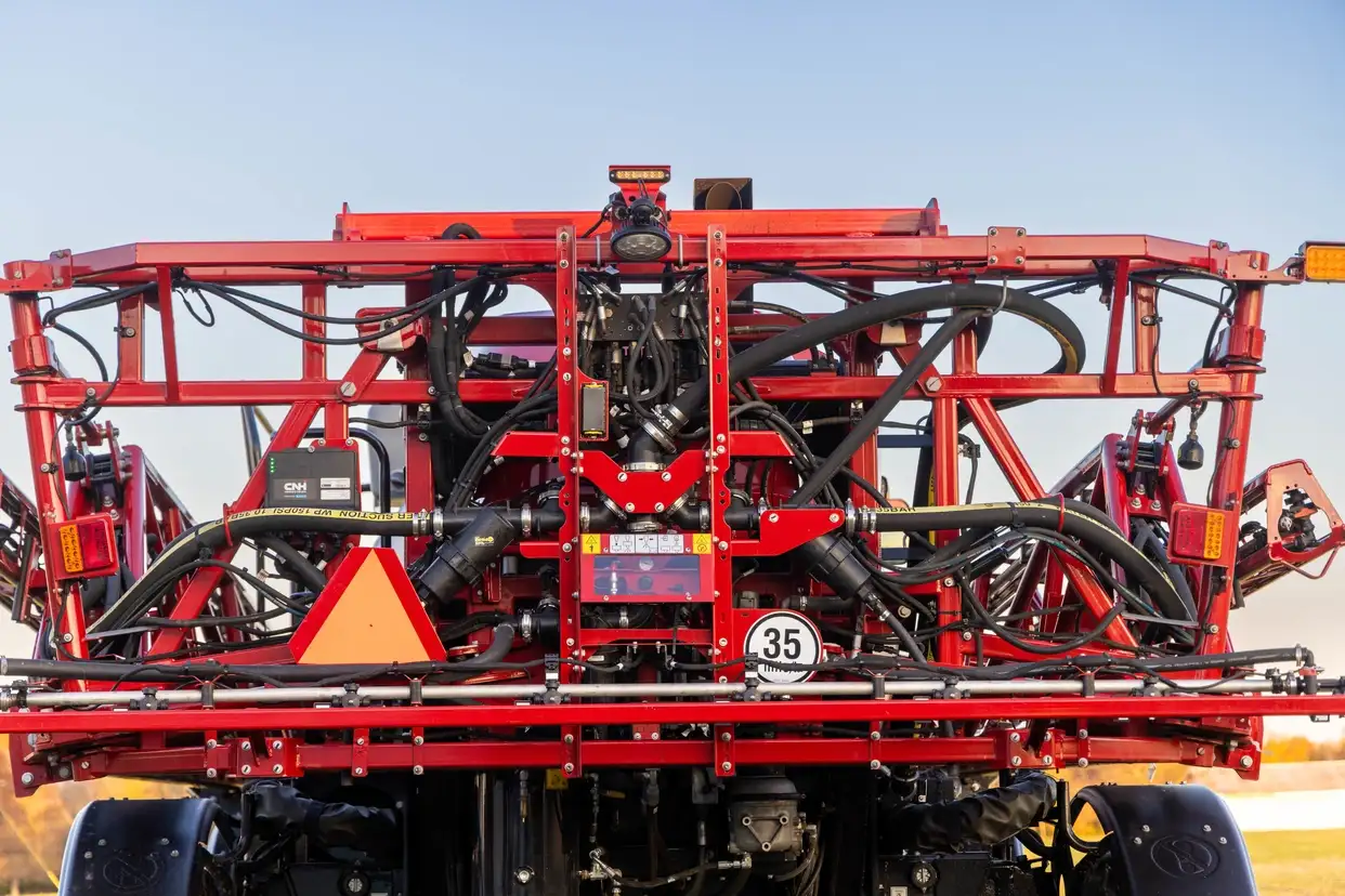 The boom and central components of a Case IH Patriot sprayer with rate control technology.