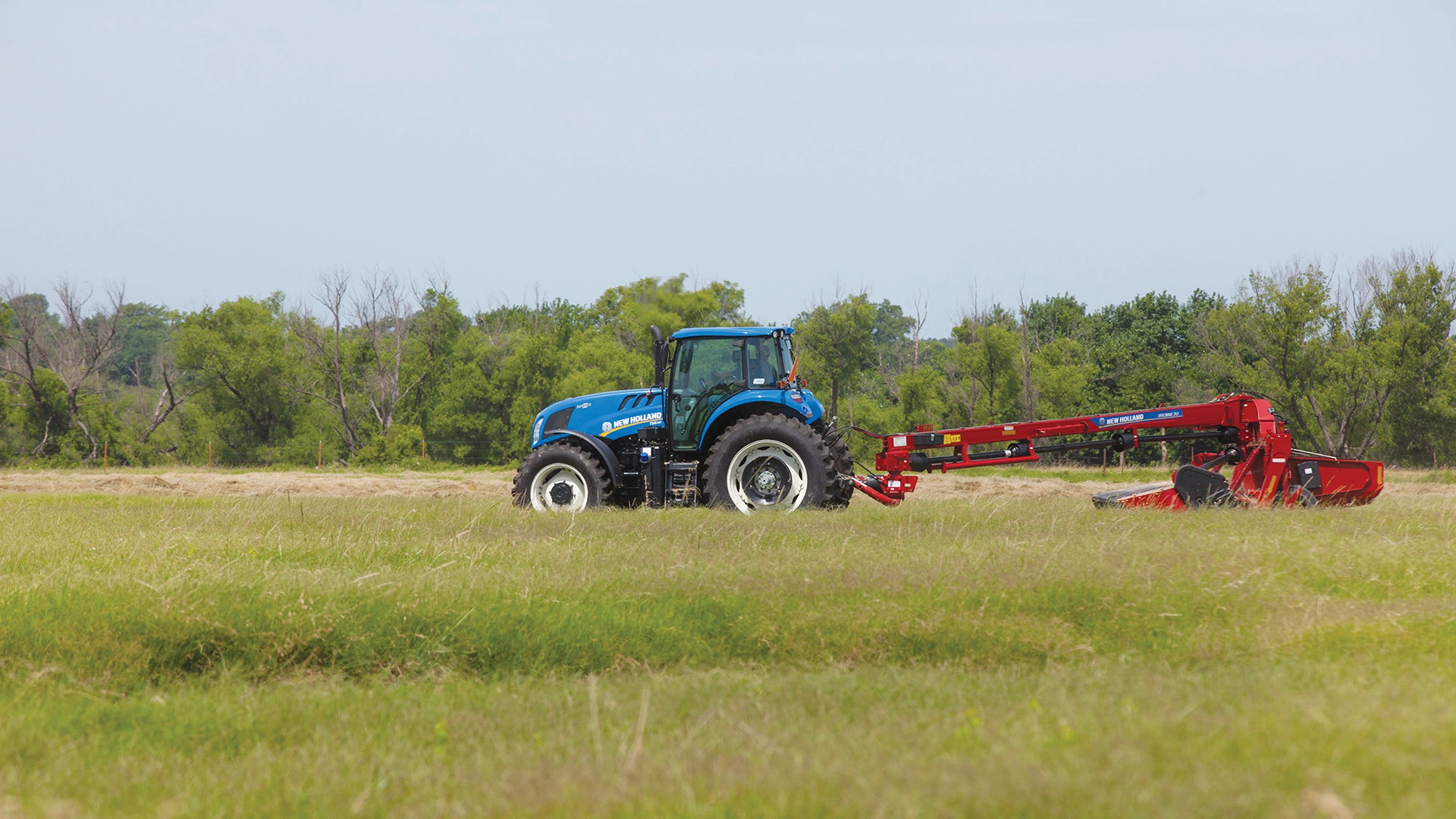 TS6 Series II tractor pulls a disc mower-conditioner