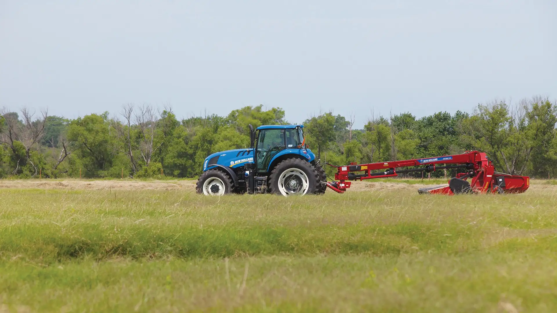 TS6 Series II tractor pulls a disc mower-conditioner