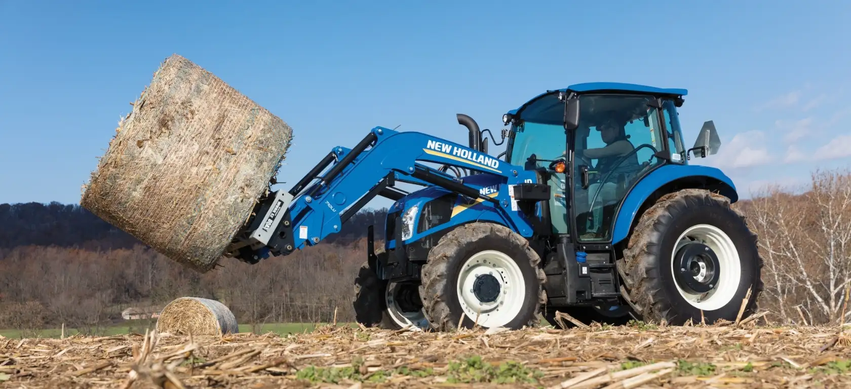 PowerStar Tractor holds a bale 