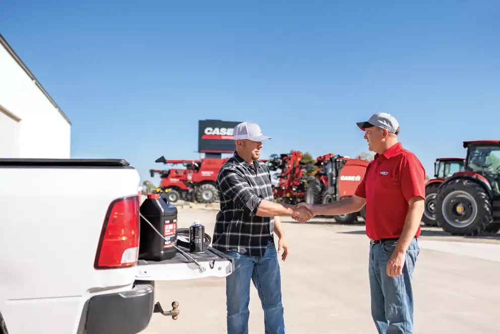 producer with dealer in dealership lot