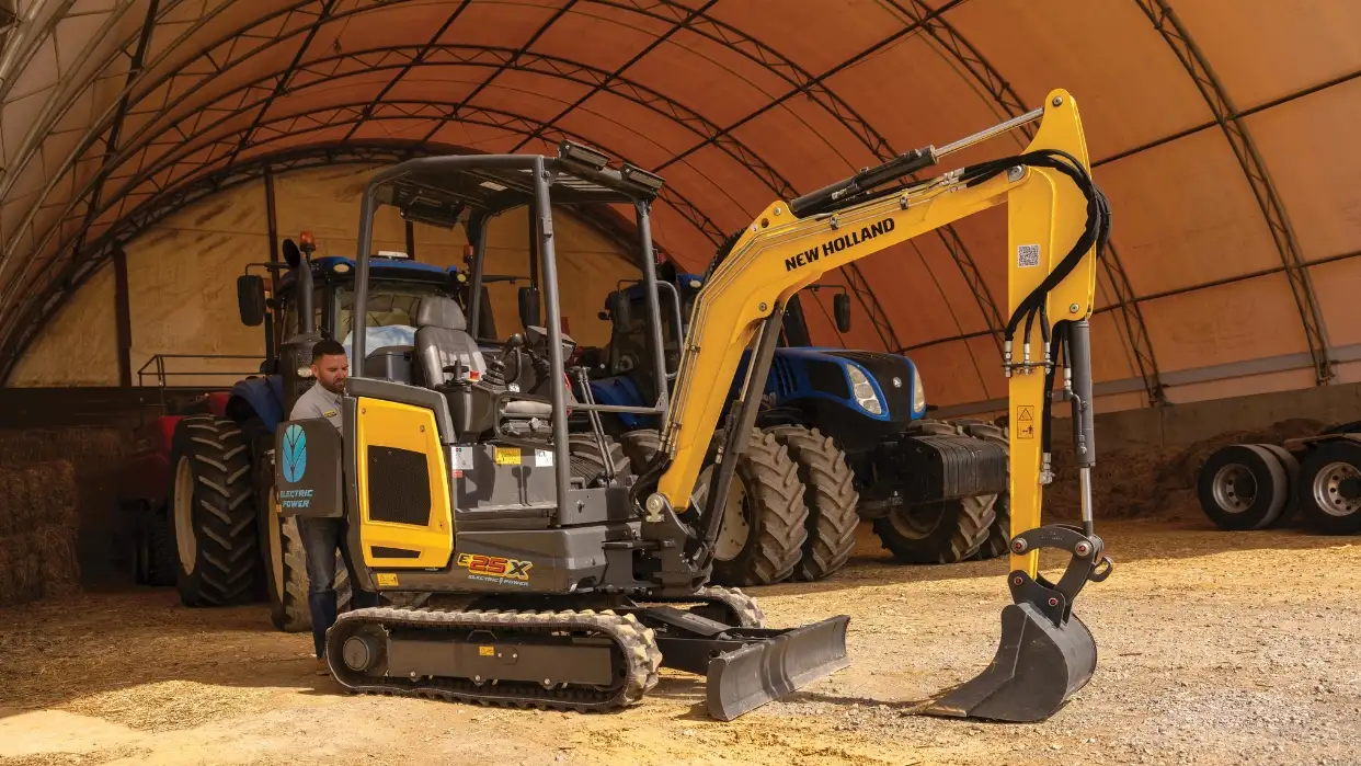 Man working on E25X excavator.
