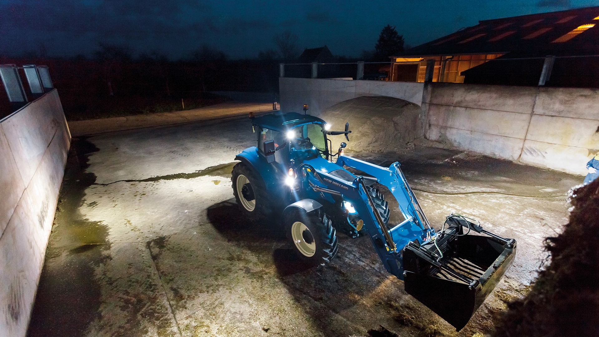 New Holland T5 Electro Command agricultural tractor working at night