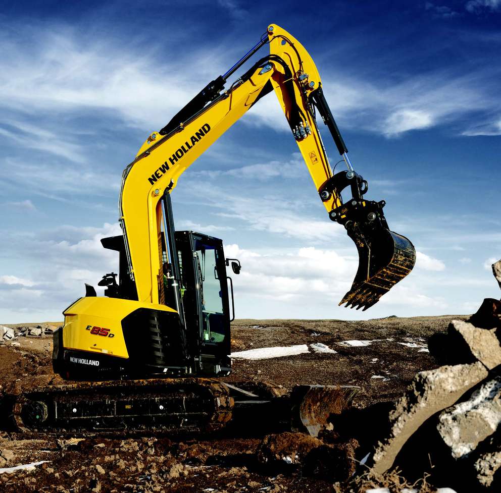 E85D mini excavator in a field.