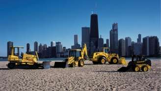 Vintage New Holland Construction Equipment line up on a beach.